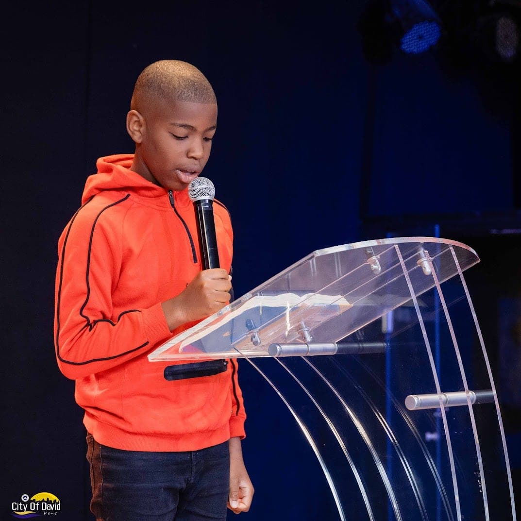 A young person speaking at the lectern