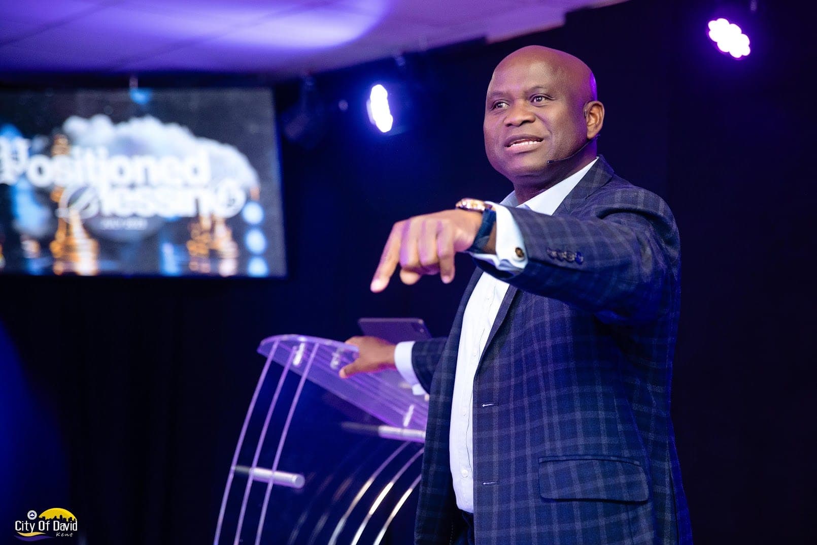 Preaching under purple stage light